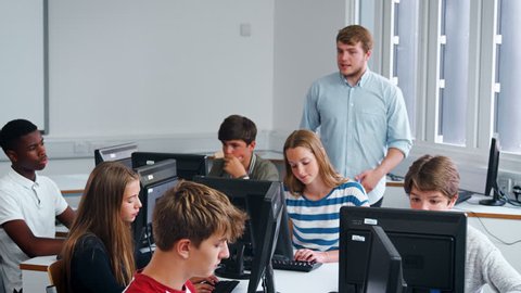 Teenage Students Studying In IT Class With Teacher