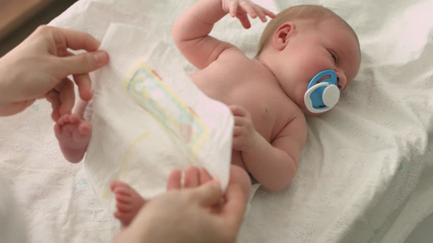 Careful mother changes diapers to her newborn baby | Shutterstock HD Video #1008885026