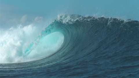 SLOW MOTION CLOSE UP: Breathtaking turquoise barrel wave crashes on a perfect summer day at the sea. Beautiful glistening tube wave crashes in the middle of the breathtaking ocean. Powerful water rush