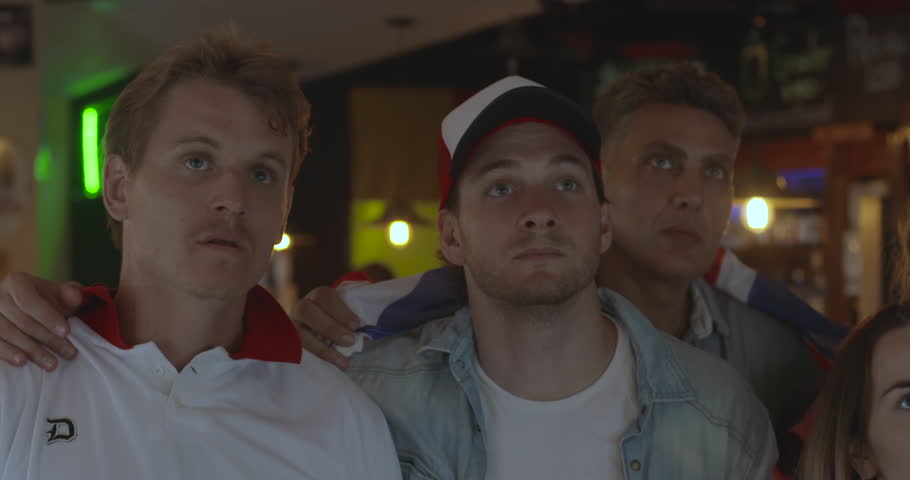 British football fans reacting to defeat while watching match in sports bar, slow motion Royalty-Free Stock Footage #1008892331