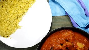 Serving Chicken Madras Curry On A Plate With Pilau Rice