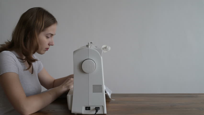 Beautiful woman sewing a pillowcase