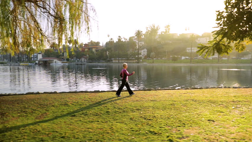 71 year old woman going for her morning walk in the park.