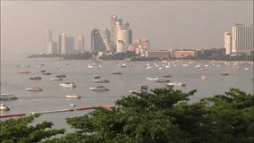 Pattaya city, Pattaya bay timelapse video.Sailing ships, sailboats at Pattaya city. Pattaya city beach and Gulf of Siam in Thailand, Asia. Floating boats and ships and skyscrapers.