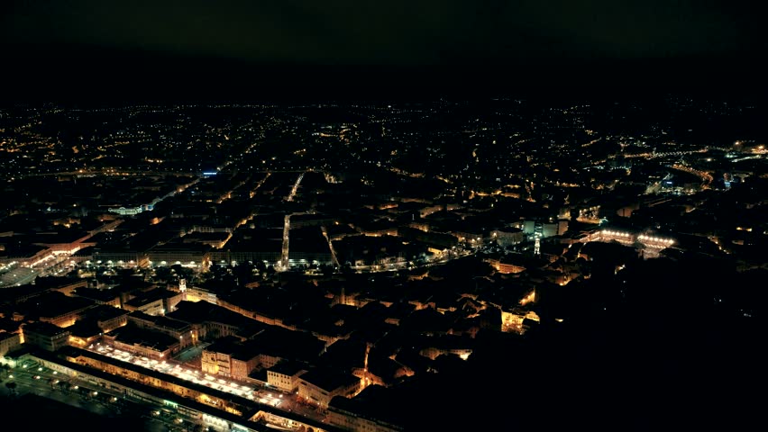 Night aerial panorama of illuminated Nice town in France. Flight over promenade.