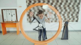 Child looks at the perpetual motion machine in the children's scientific museum. Concept of physics