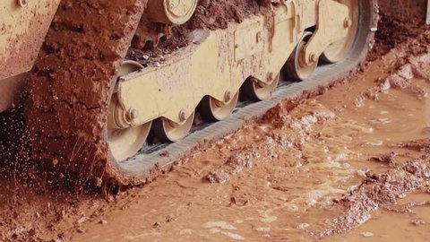 Construction equipment driving through mud