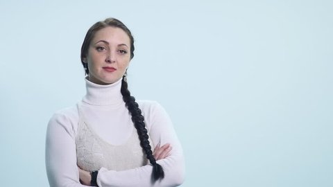 The girl looks skeptical, haughty, suspects, on a white background