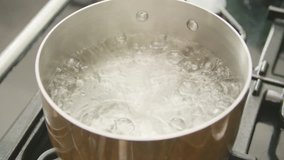 Closeup Of Boiling Water In Hot Cookware At Kitchen