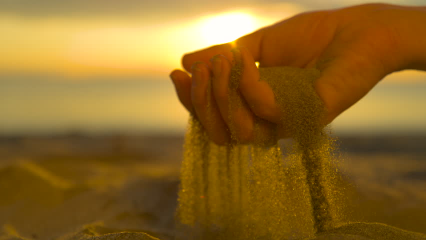 SLOW MOTION, CLOSE UP: Unrecognizable woman grabs a handful of dry sand and lets it fall between her fingers. Young traveler on a sunny beach in Fiji sifts coarse beach sand between her fingertips. Royalty-Free Stock Footage #1008924149