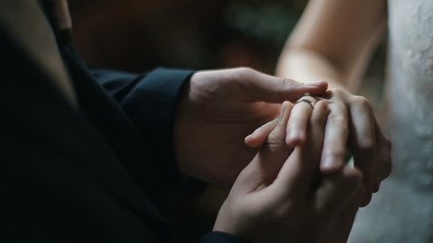 The groom puts the wedding ring on finger of the bride. marriage hands with rings. The bride and groom exchange wedding rings.