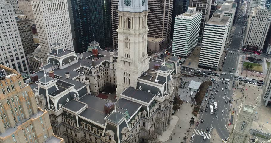 Close aerial view frames Philadelphia City Hall’s ornate tower, rooftops, streets, and surrounding Center City skyscrapers, 2018.