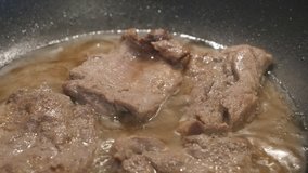 Close-up steaks of pork in frying pan  4K 2160p 30fps UltraHD footage - 
