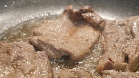 Pork meat in frying pan close-up 4K 2160p 30fps UltraHD footage 