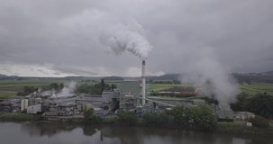 Aerial Shot of Factory with White smoke coming out of chimney slow tracking shot two
