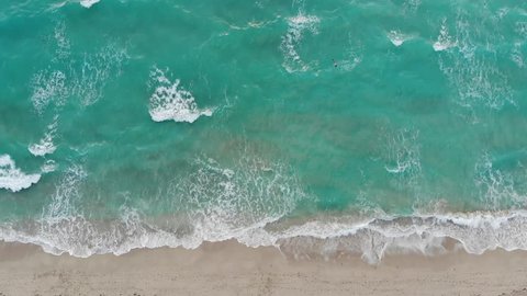 Rough wall of waves crashing view from an aerial perspective looking down at the shoreline in Miami Beach