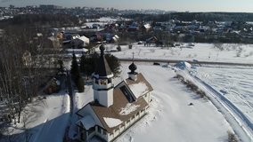 Aerial view video of The Church of the Smolensk icon of the Mother of God in the village Podolino, Moscow region, Russia. Russian winter landscape around