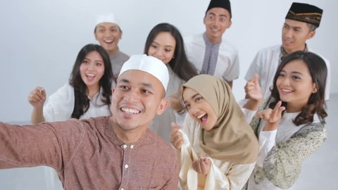 Group of happy muslim friends taking selfie together. eid mubarak ramadan kareem concept