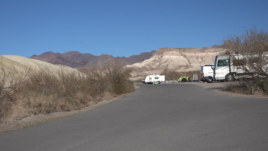 Campground views near Furnace Creek in Death Valley National Park. Campers in trailers, RVs, and motorhomes.