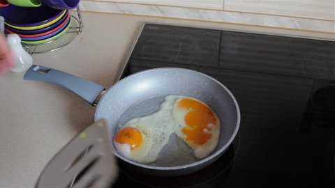 flipping eggs on stove