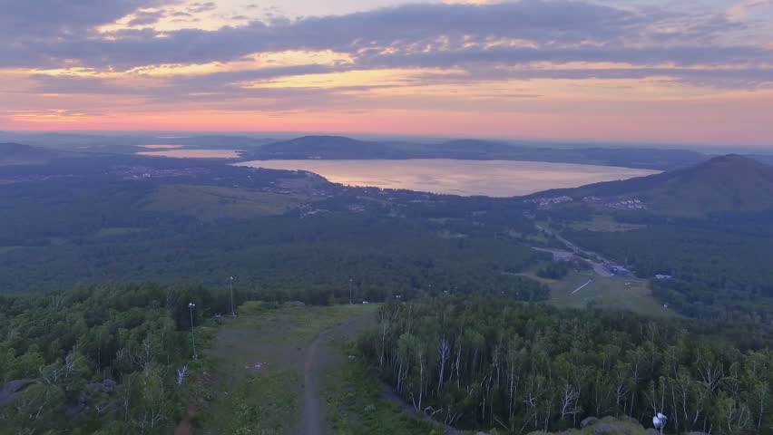 AERIAL: A colorful dawn on Lake Yakty-Kul, Bashkortostan. eautiful landscape of the valley, large lakes and a mountain chain on the horizon.