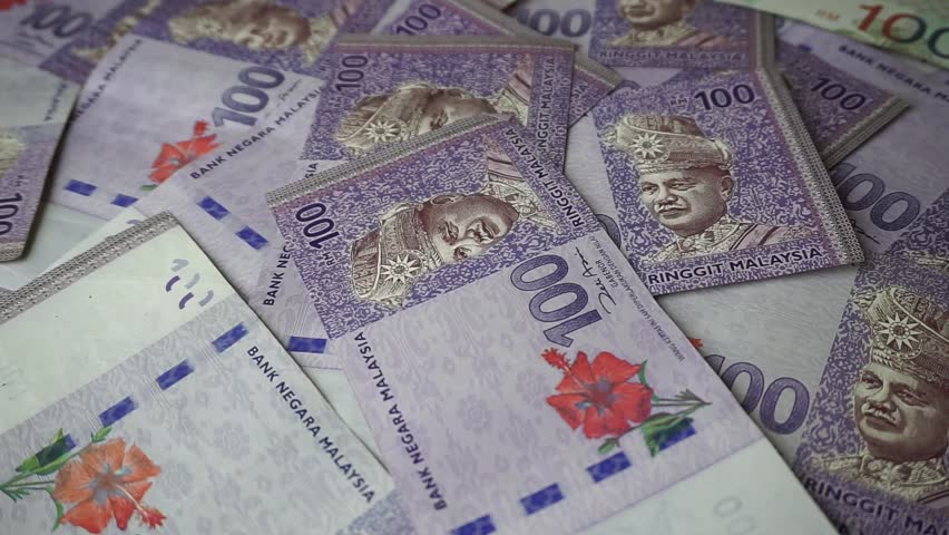 Malaysia Currency (MYR): Stack of Ringgit Malaysia bank note. There is a hundred ringgit malaysia scattered on the table. | Shutterstock HD Video #1008975086
