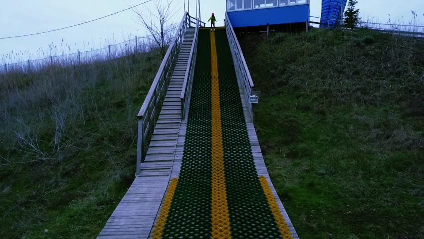 5 years little boy doing a back flip on skis