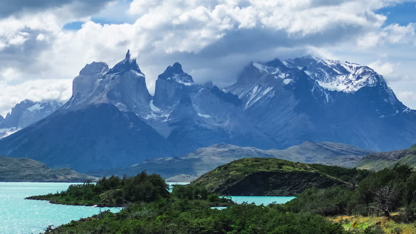 Torres del Paine National Park. Zoom in timelapse of the running clouds in mountains with lakes and meadow on the foreground, Patagonia, Chile