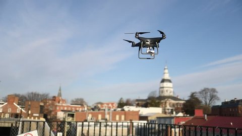 Annapolis, MD - March 10, 2018: A DJI Phantom 4 Pro Obsidian edition drone / quadcopter takes off from a parking garage and prepares to fly over the historical part of the city.