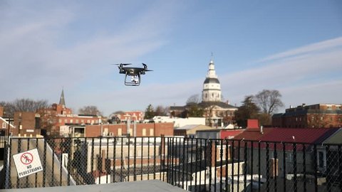 Annapolis, MD - March 10, 2018: A DJI Phantom 4 Pro Obsidian edition drone / quadcopter takes off from a parking garage and prepares to fly over the historical part of the city.