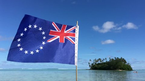 Cook Islands Ensign against a small islet in Muri lagoon Rarotonga. Pacific Island travel holiday vacation concept