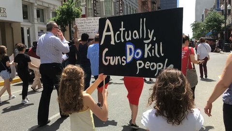 NEW OLREANS, LOUISIANA CIRCA MARCH 2018 - Two Children girls holding "Guns Do Kill People" sign in March for our lives demonstration