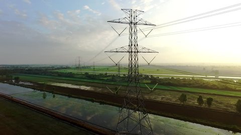view footage of high voltage electricity tower and power lines under the beautiful sky