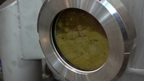 Modern Craft Brewery. Circulating beer with hop in the Hop Extractor (IPA production). 