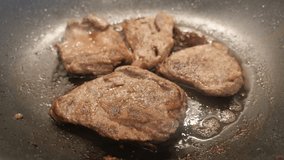 Fresh meat in hot oil close-up 4K 2160p 30fps UltraHD footage - Preparing of  pork steaks in frying pan 3840X2160 UHD video