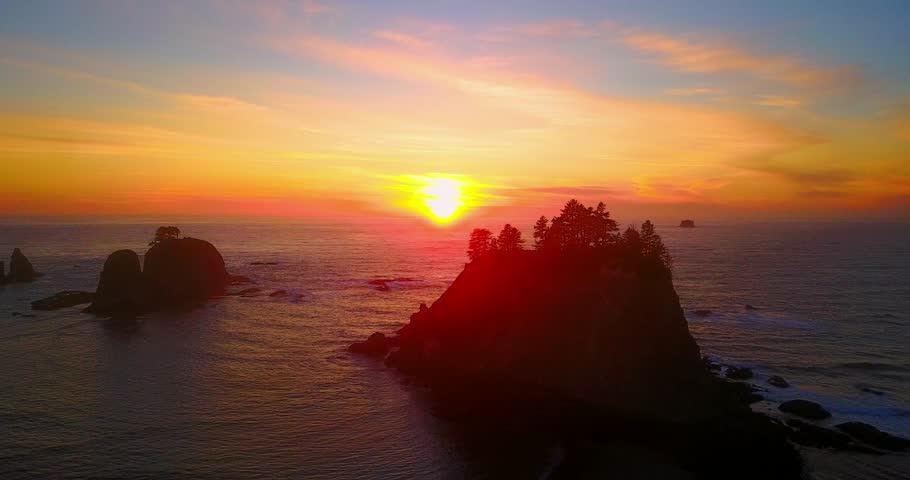 Pine Island Sunset In Pacific Northwest With Red And Orange Sunset And Silhouette - Rialto Beach, Washington, USA - 4K Aerial Footage