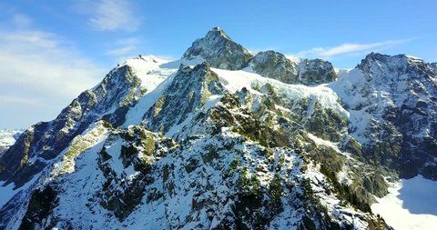 Dramatic Snowy Mountain Peaks With Sharp Ridges And Rocky Peaks - Mount Shuksan, Washington, USA - 4K Aerial Drone Footage
