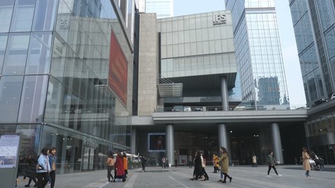 Chengdu Mar 1,2018: slow motion of people walking in the IFS (International Finance Square) by the office building