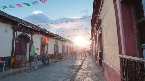 People walking at sunset on the main street of San Cristobal de las Casas, Chiapas. 4k