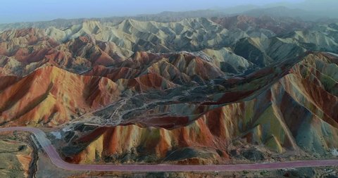 Flying through most spectacular section of Zhangye Danxia National Geopark showing colorful rainbow mountains covered with unique patterns.
