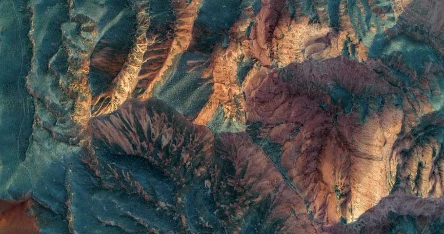 Colorful nature. Aerial view on orange sandstone hills covered with sparse vegetation in Zhangye Danxia National Geopark.  Royalty-Free Stock Footage #1009018748