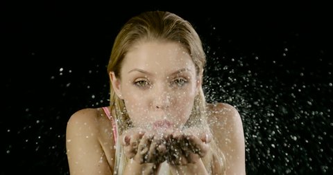 Pretty Woman blows glitter at the camera. Slow Motion