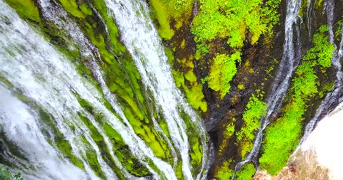 Mossy Waterfall Cascade With Bright Green And Brown Colors - Overhead Aerial Panning Shot - 4K Drone Footage
