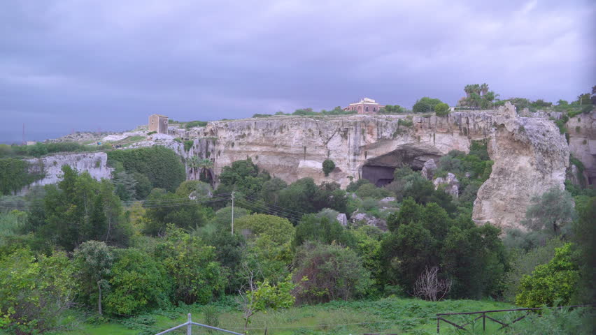 The trees on the front of the mountain in Neapolis Siracusa Italy found in the archeological park in Sicily