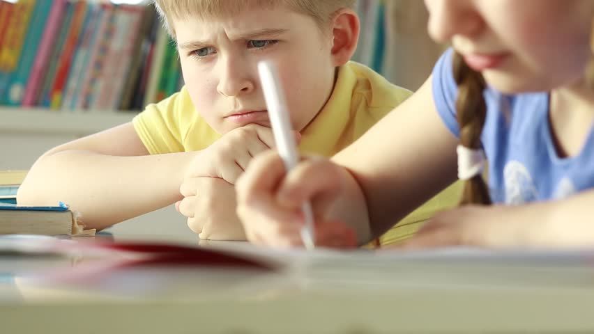 A sad child in classroom. Tired schoolboy. Elementary school student. Royalty-Free Stock Footage #1009029434