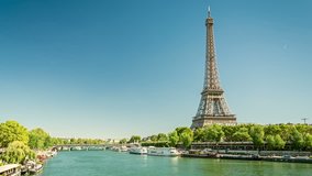 River Seine and Eiffel tower, one of the most recognisable landmarks of the world and Paris city symbol. Clear blue sky, sunny summer day. Timelapse video.