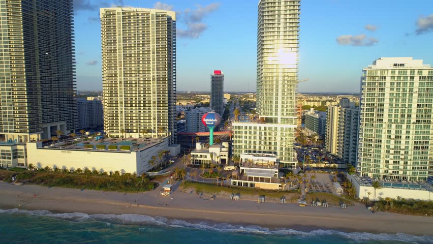 Aerial Hallandale Beach water tower approach reveal tilt down 4k 24p