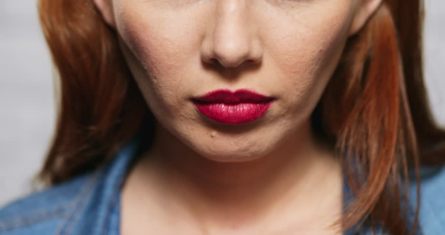 Closeup of angry woman. Redhead girl showing fear, terror and frustration. Slow motion