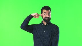 Handsome man making crazy gesture on green screen chroma key