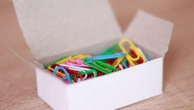 Taking paper clips from box
